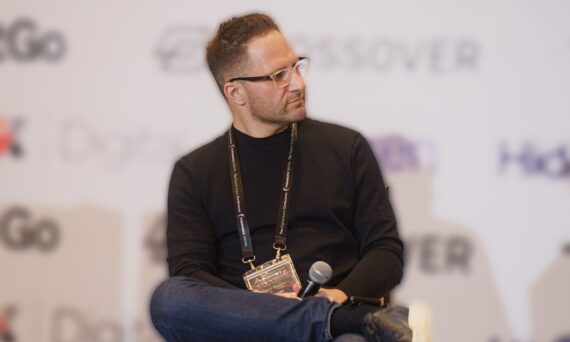 Alex Ryvkin sitting on stage.